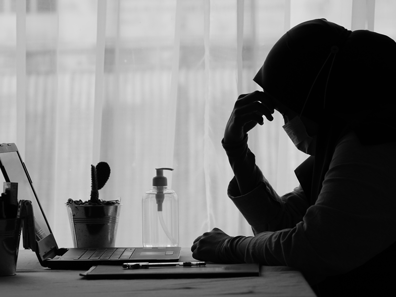 Moslima zit verslagen aan tafel